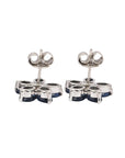 Silver ear studs in blue sapphire and diamond flower