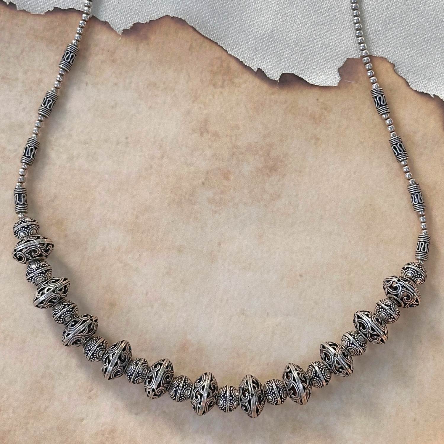 Silver beaded necklace on a textured surface

Silver Jewelry
925 Silver 
intricate Design Jewelry 