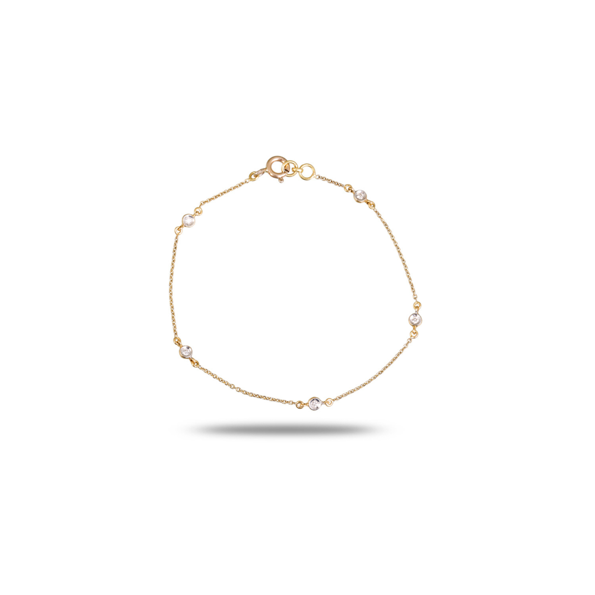 18K yellow gold diamond station bracelet with five round brilliant bezel-set diamonds evenly spaced on delicate cable chain, spring ring clasp, circular display on white background