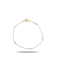 18K yellow gold diamond station bracelet with five round brilliant bezel-set diamonds evenly spaced on delicate cable chain, spring ring clasp, circular display on white background