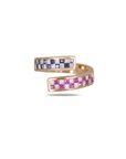 Rose gold open bypass ring with two rectangular ends upper end featuring blue sapphire and diamond checkerboard grid, lower end featuring pink sapphire and diamond checkerboard grid, princess cut stones in two-row channel